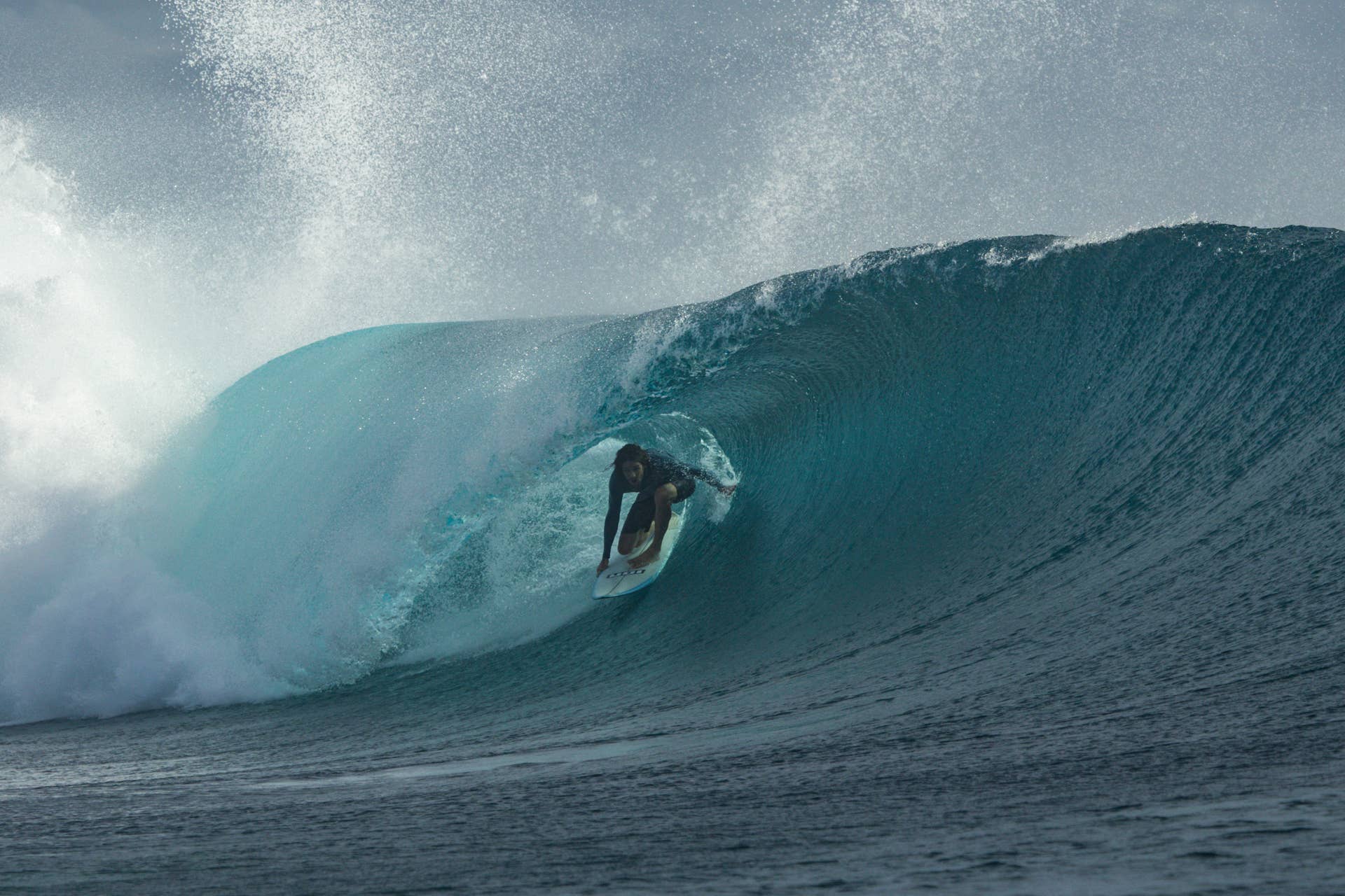 Surfer on a wave in Fiji