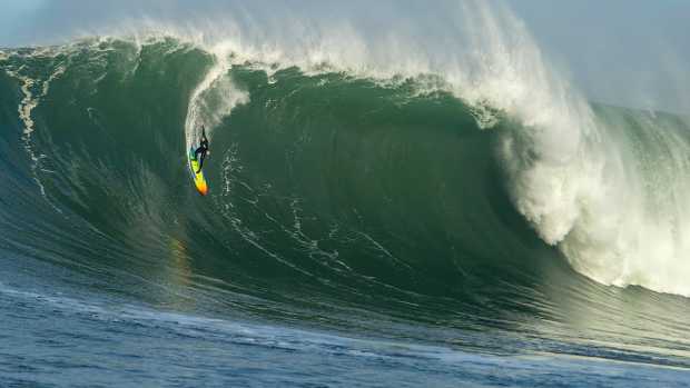 Jojo Roper rides a huge wave at Mavericks.