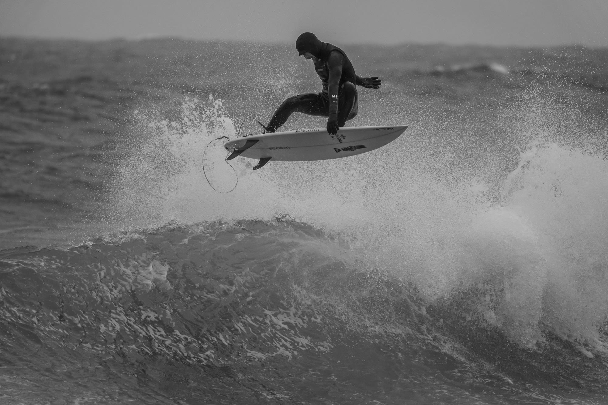Pete Devries does an aerial maneuver off a wave in the Bering Sea.