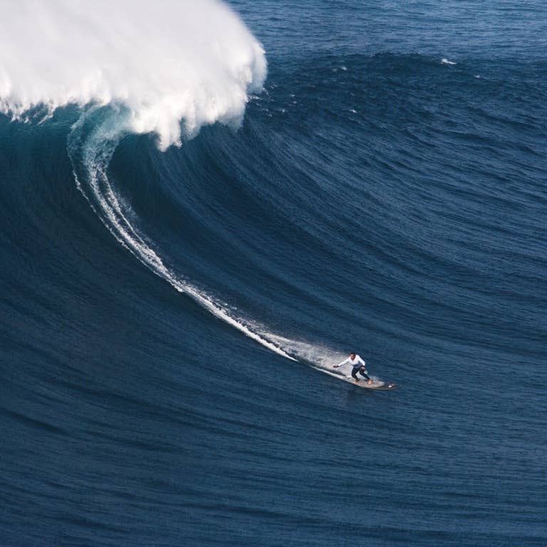 Garrett McNamara Surfs Giant Wave On A WaveJet Propelled Gun - Surfer